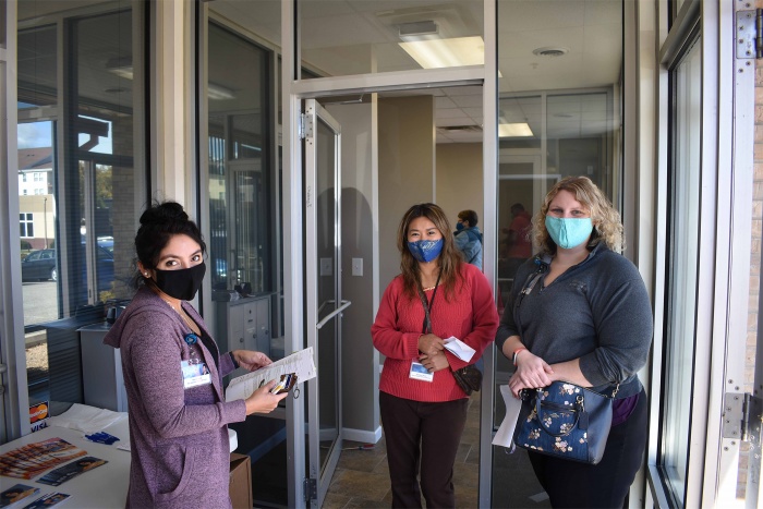 three female mefcu staff members wait to receive flu shots