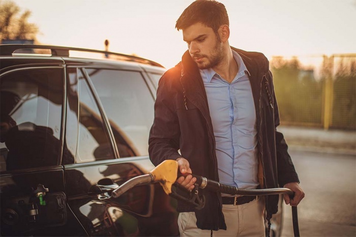 Man filling up car with fuel