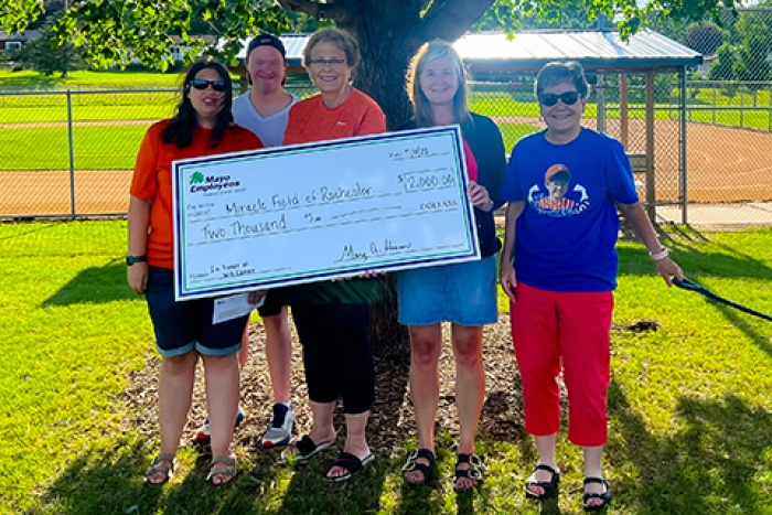 MEFCU CEO Mary Hansen awarding check to Miracle Field of Rochester