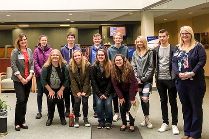 chelsea cliff and venessa mandelkow of mefcu, standing with ten high school students