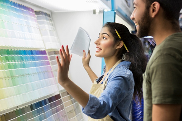 woman showing man paint sample display