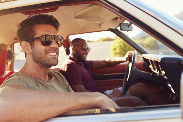 men driving in a car