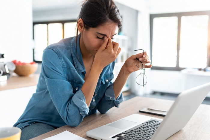 Distressed woman holding her face