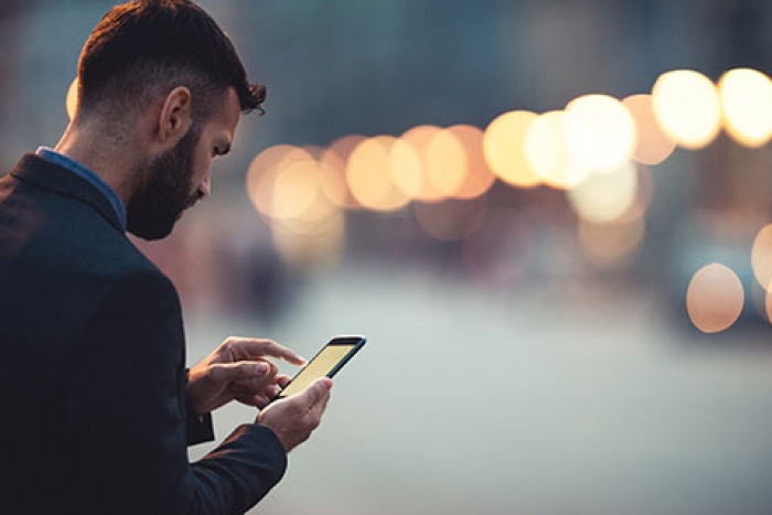 man looking at phone screen