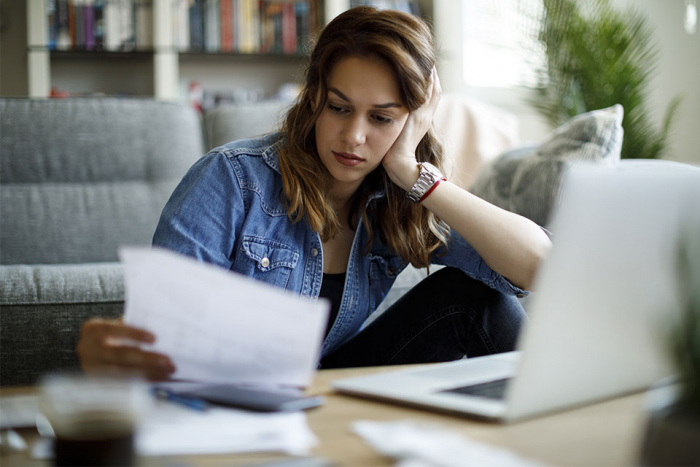 woman studying a report at home