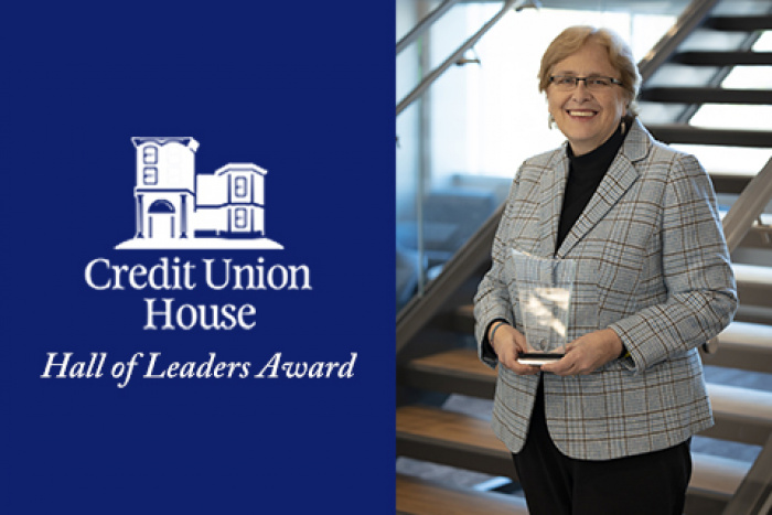 Mary Hansen, MEFCU CEO, holding award