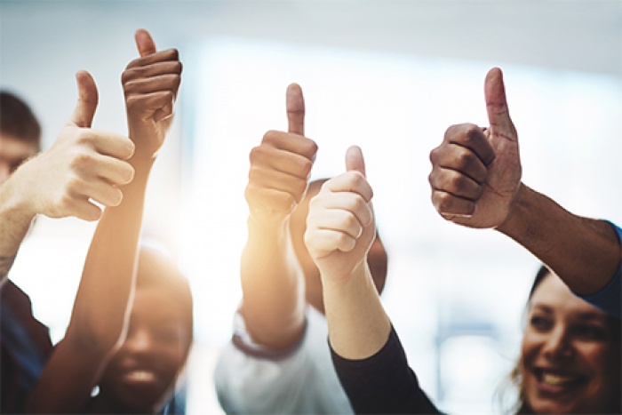 group of people giving a thumbs up